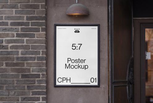 Urban outdoor poster mockup displayed on a brick wall with lighting for realistic design presentations, suitable for advertising projects.